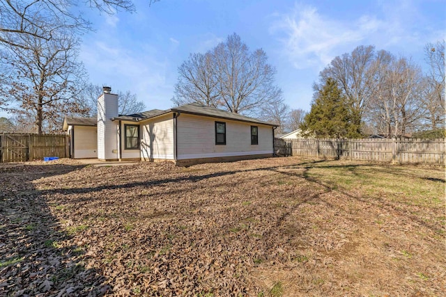 back of house with a yard