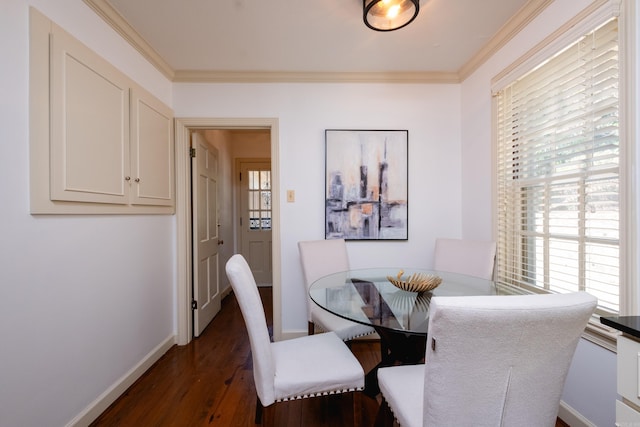 dining space with dark hardwood / wood-style flooring and crown molding