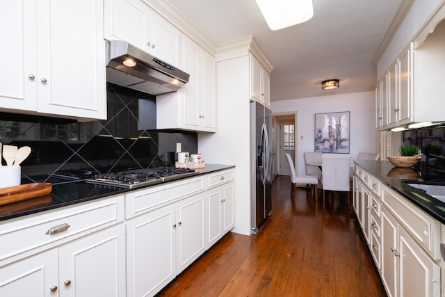 kitchen with tasteful backsplash, white cabinetry, and appliances with stainless steel finishes