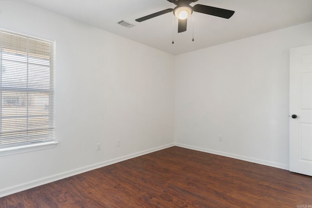 unfurnished room featuring dark wood-type flooring and ceiling fan