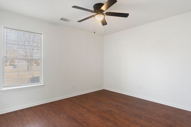 empty room featuring ceiling fan and dark hardwood / wood-style flooring