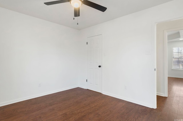 empty room with dark hardwood / wood-style floors and ceiling fan