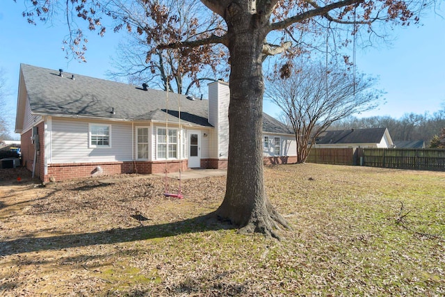 rear view of property with a yard and a patio