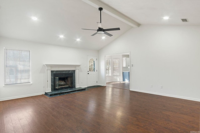 unfurnished living room featuring high vaulted ceiling, dark hardwood / wood-style flooring, beamed ceiling, ceiling fan, and a high end fireplace