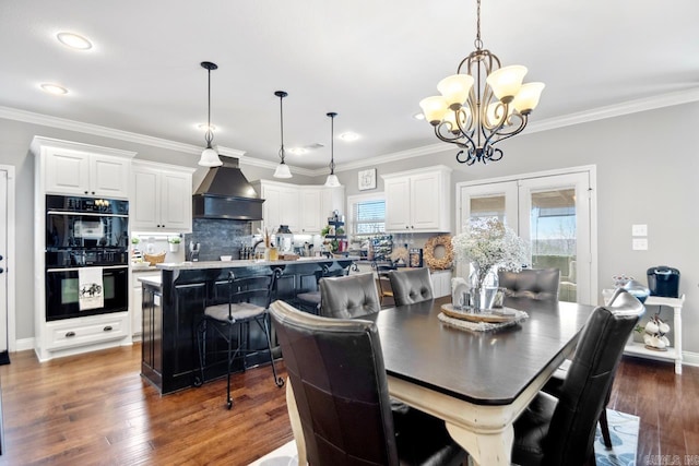 dining room with crown molding, dark hardwood / wood-style floors, french doors, and a notable chandelier