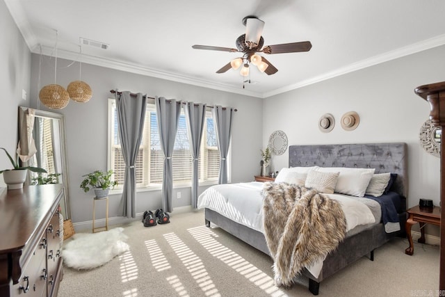 carpeted bedroom featuring crown molding and ceiling fan