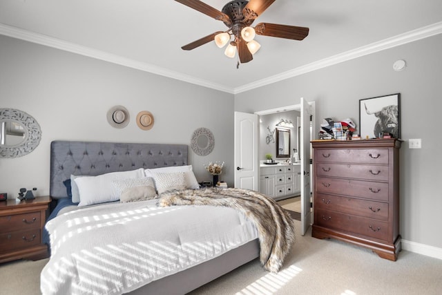 carpeted bedroom featuring ensuite bathroom, ornamental molding, and ceiling fan