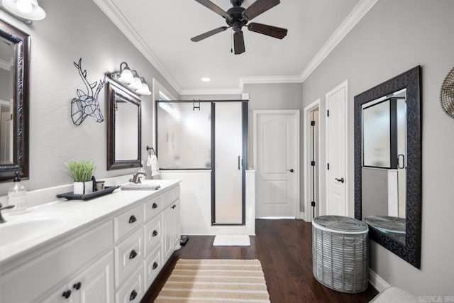 bathroom featuring hardwood / wood-style flooring, ornamental molding, and a shower with door