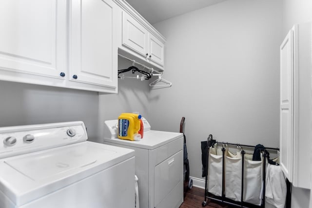 washroom with cabinets, dark hardwood / wood-style flooring, and washer and dryer