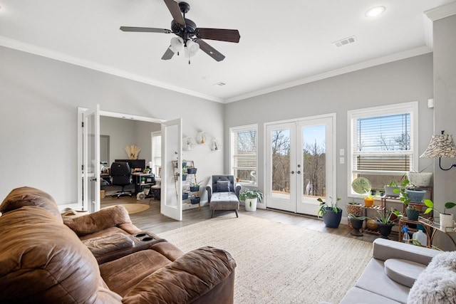 living room featuring french doors, plenty of natural light, and light hardwood / wood-style floors