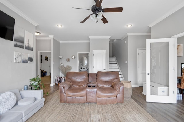 living room with crown molding, ceiling fan, and hardwood / wood-style floors