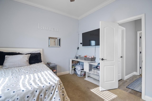 bedroom with ornamental molding, ceiling fan, and carpet flooring