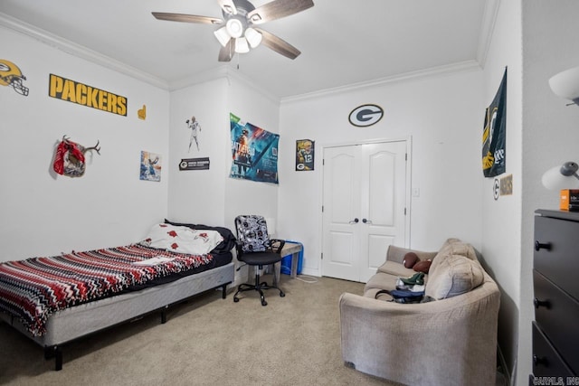 bedroom with ceiling fan, ornamental molding, light carpet, and a closet