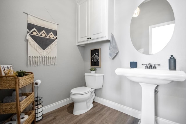 bathroom featuring hardwood / wood-style flooring and toilet