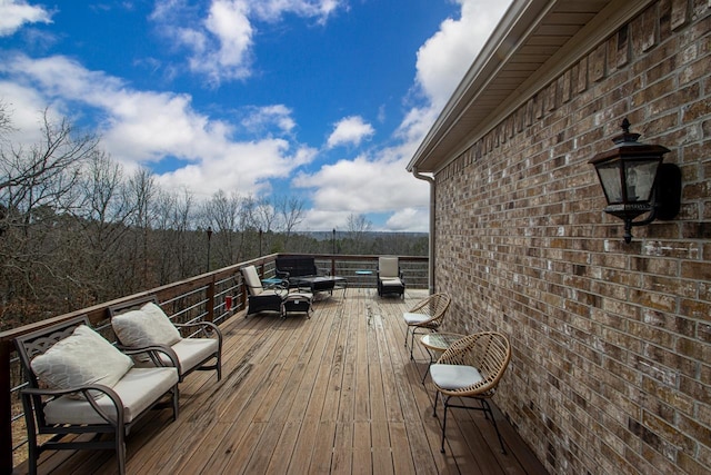 wooden deck with an outdoor living space