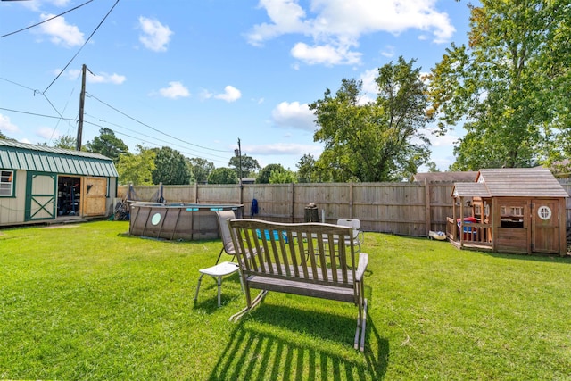 view of yard with a storage shed and a fenced in pool