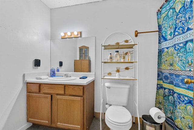 bathroom featuring vanity, curtained shower, and toilet