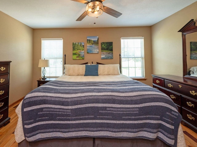 bedroom with light wood-type flooring and ceiling fan