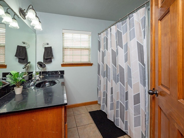 bathroom featuring tile patterned flooring, vanity, and a textured ceiling