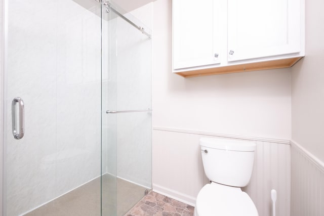 bathroom featuring toilet and walk in shower