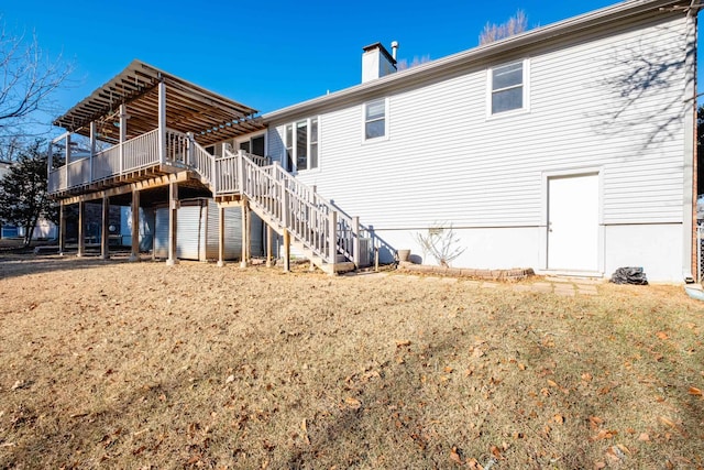 back of property featuring a yard and a deck