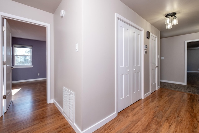 corridor featuring wood-type flooring