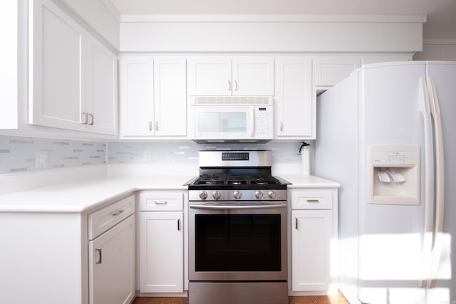 kitchen featuring tasteful backsplash, white appliances, crown molding, and white cabinets