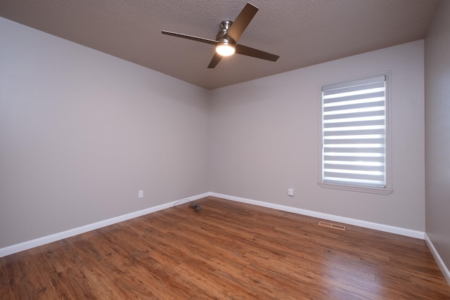 unfurnished room with ceiling fan, hardwood / wood-style floors, and a textured ceiling