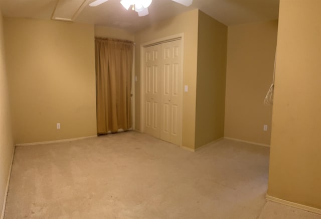 unfurnished bedroom featuring ceiling fan, carpet flooring, and a closet