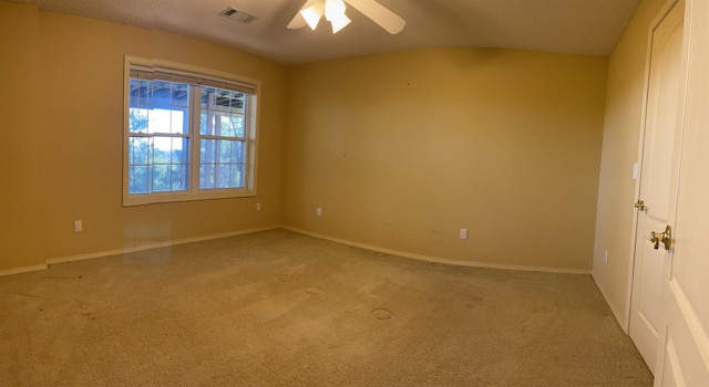 carpeted empty room featuring a textured ceiling and ceiling fan