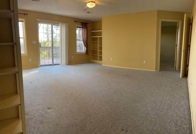 carpeted spare room with ceiling fan