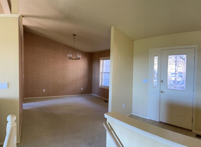 entryway featuring light colored carpet and lofted ceiling