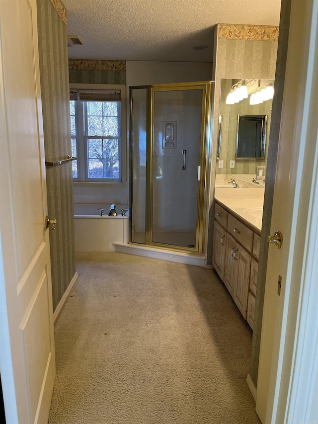 bathroom featuring vanity, plus walk in shower, and a textured ceiling