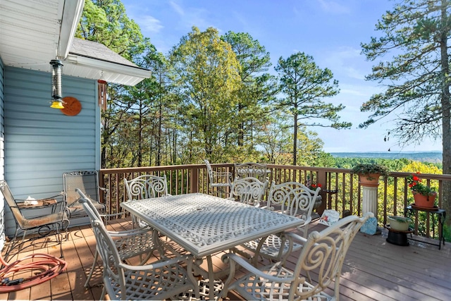 wooden terrace featuring a water view