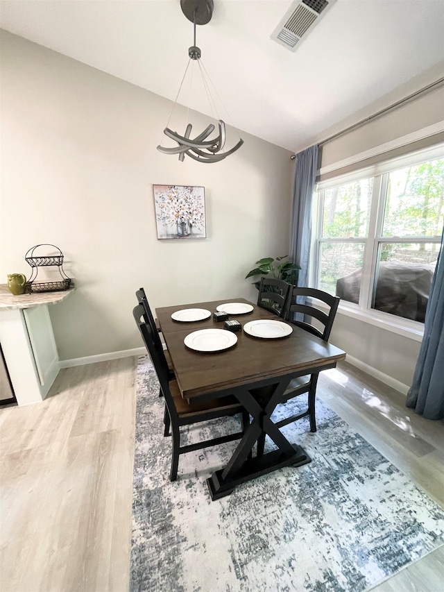 dining space with wood-type flooring