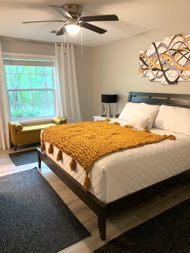 bedroom featuring hardwood / wood-style floors and ceiling fan