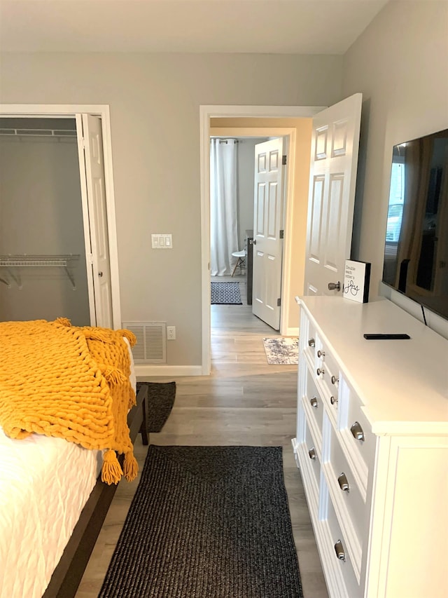 bedroom with hardwood / wood-style flooring and a closet