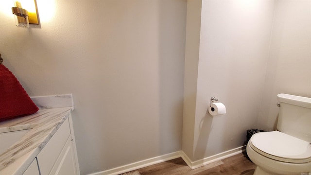 bathroom with sink, hardwood / wood-style floors, and toilet