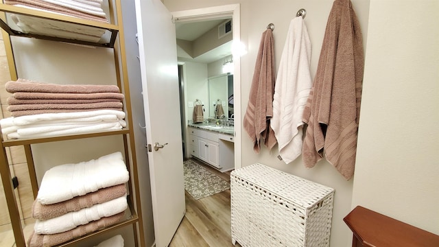 bathroom with vanity and hardwood / wood-style floors