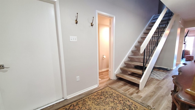 stairway with hardwood / wood-style flooring