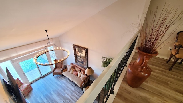 staircase featuring hardwood / wood-style floors and a notable chandelier