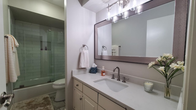 full bathroom with vanity, enclosed tub / shower combo, and toilet