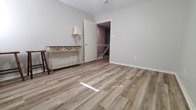 unfurnished room featuring ceiling fan and light wood-type flooring