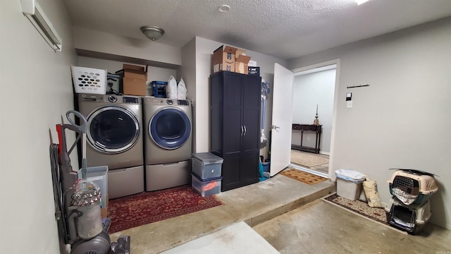 washroom featuring separate washer and dryer and a textured ceiling