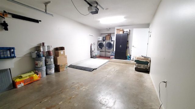 garage featuring separate washer and dryer and a garage door opener