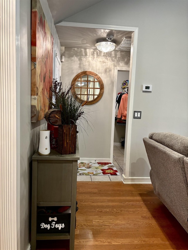 hallway with hardwood / wood-style floors