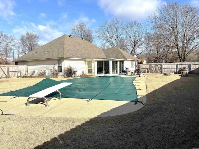 view of pool with a patio area and a diving board