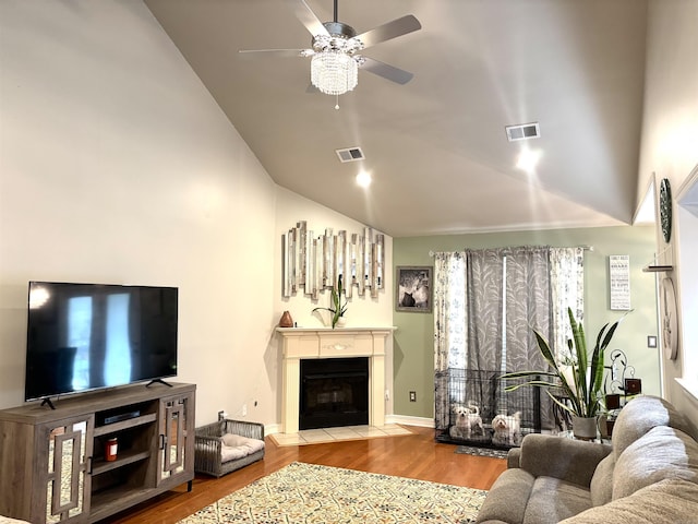 living room with hardwood / wood-style flooring, ceiling fan, and lofted ceiling