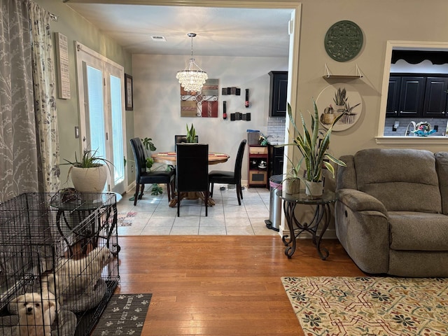 dining space featuring hardwood / wood-style flooring and a chandelier