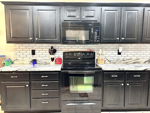 kitchen featuring light stone countertops, decorative backsplash, and black appliances